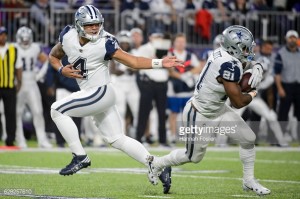 MINNEAPOLIS, MN - DECEMBER 1: Dak Prescott #4 of the Dallas Cowboys hands off the ball to teammate Ezekiel Elliott #21 against the Minnesota Vikings during the game on December 1, 2016 at US Bank Stadium in Minneapolis, Minnesota. (Photo by Hannah Foslien/Getty Images)